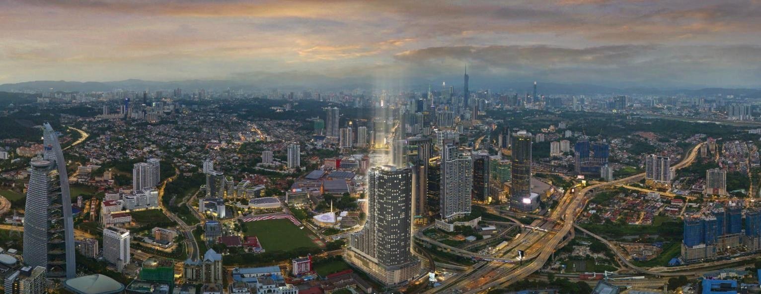 Aerial dusk view of the Khaya Residences tower rising above the Kuala Lumpur skyline near Bangsar